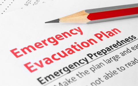 Writing an emergency evacuation plan on paper