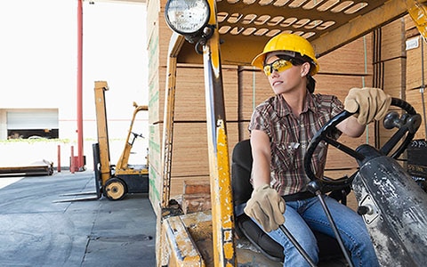 female forklift operator moving supplies