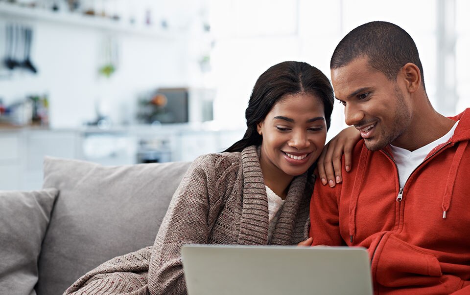 Couple researching cars to buy online