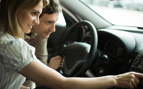 Couple looking at buying a new car