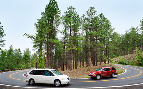 SUV and minivan on road