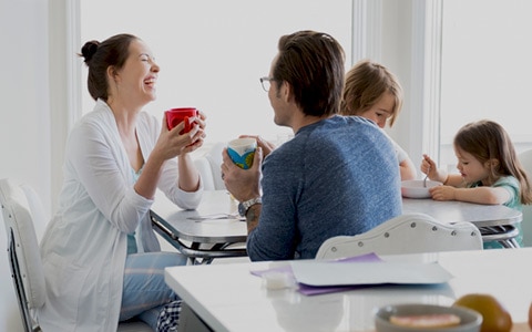 family sitting at table at home