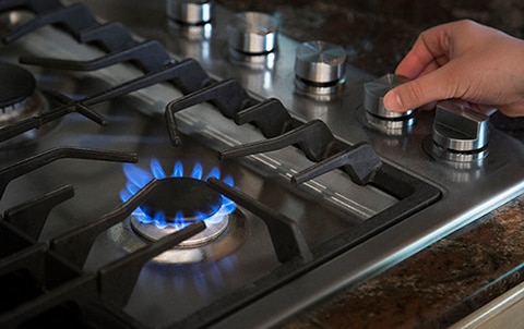 person checking oven as part of home inspection