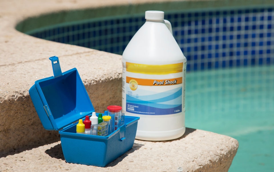 Pool shock and equipment to test water levels of a pool
