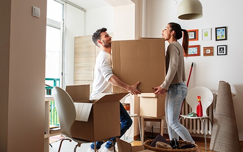Couple moving stuff from apartment into new home