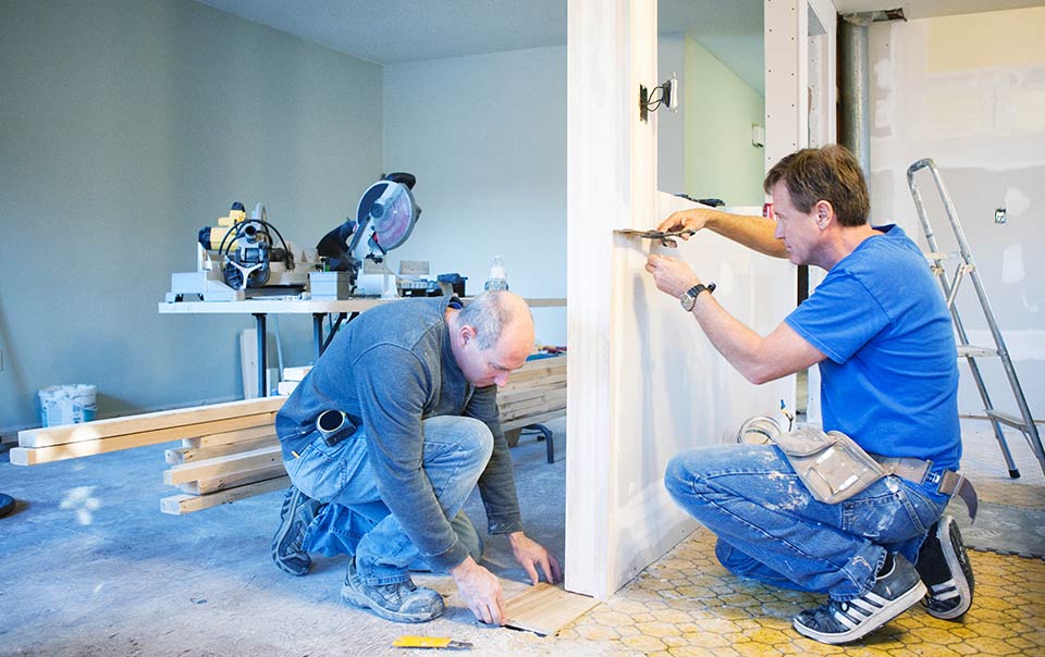 2 contractors working on kitchen in house