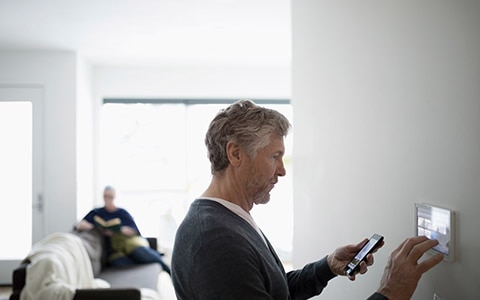 man setting up smart technology in home