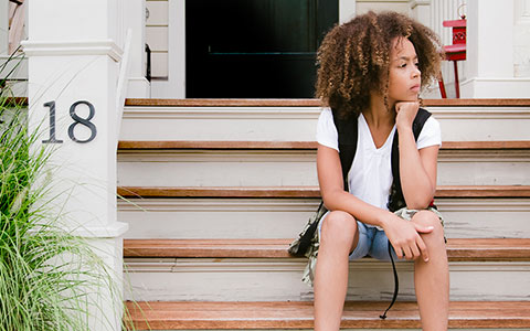 woman sitting in front of house