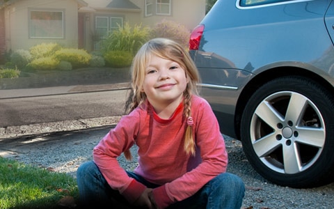 girl sitting in front of car